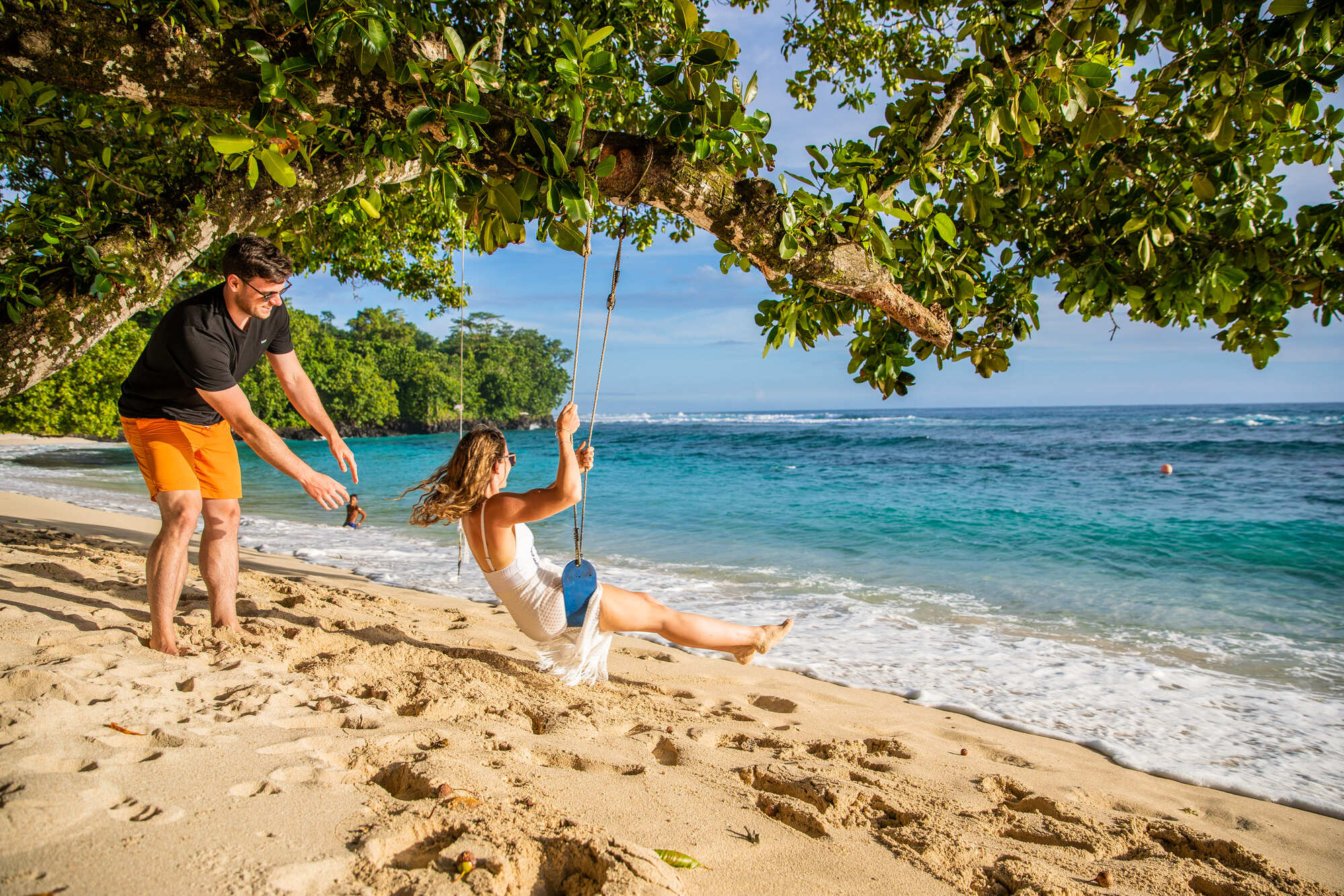 Couple swinging on tree at Aganoa Beach Samoa Aganoa Beach Samoa with Couple