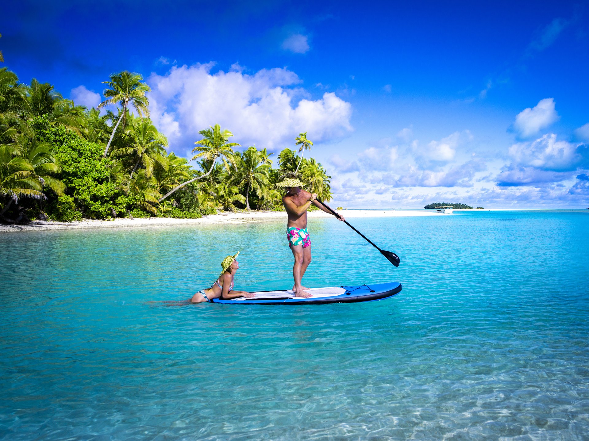 Connect and explore in the Cook Islands Couple on a SUP in Aitutaki Lagoon